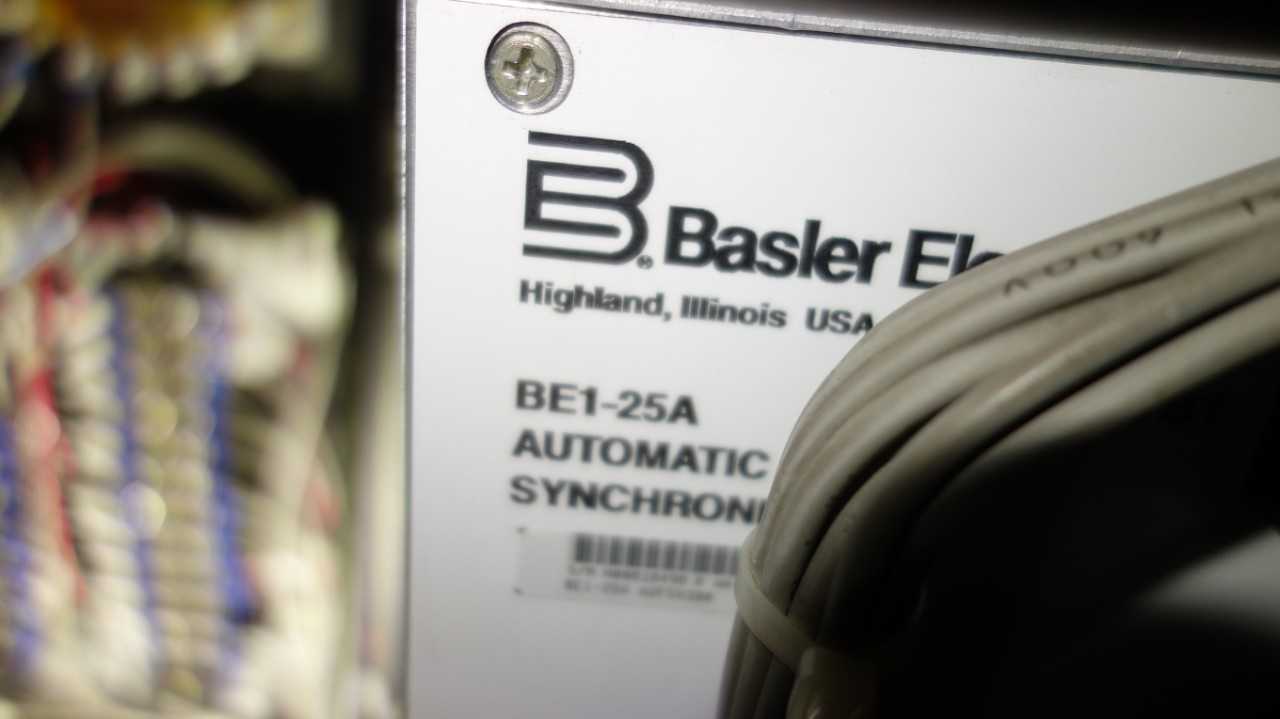 CONTENTS OF ELECTRICAL WALL, ASSORTED RELAYS, METERS, BASLER BS1-25A AUTOMATIC SYNCHRONIZER (DELAYED REMOVAL) - ELECTRICAL COMPONENTS