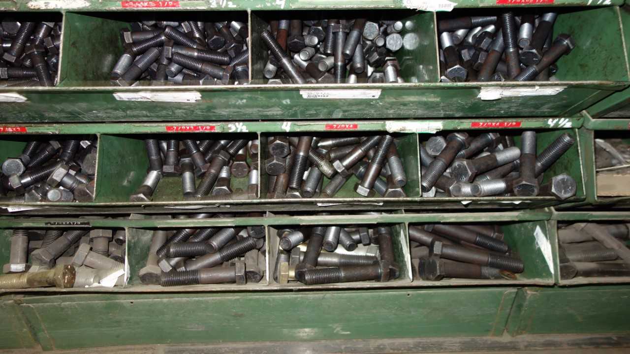 SHELVES OF ASSORTED THREADED SCREWS AND NUTS - INDUSTRIAL PARTS