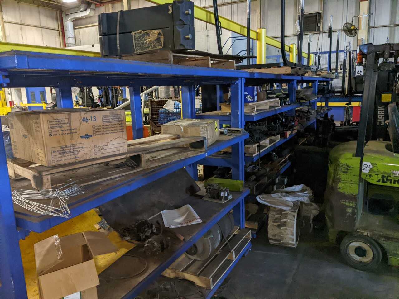CONTENTS OF 4 SECTIONS OF RACKING, ASSORTED FORKLIFT REPLACEMENT PARTS, STARTERS, FORKS, HYDRAULIC CYLINDERS, FILTERS, SEATS - PALLET RACKING