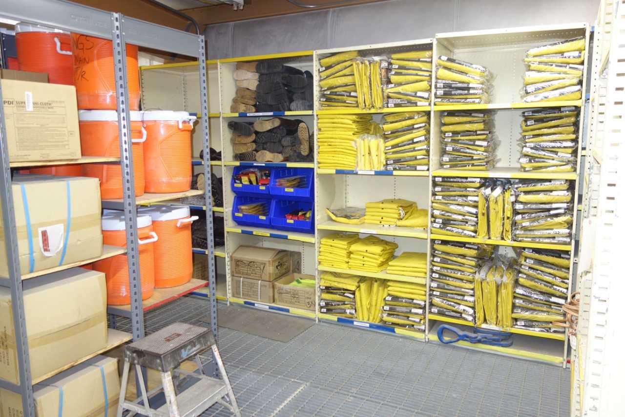 Contents of shelving - water coolers, safety clothing, rubber boots, rope, cleaning supplies - SAFETY EQUIPMENT