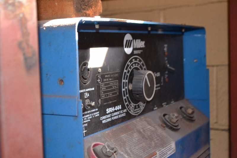 CONTENTS OF TABLE - WRENCHES, CLAMPS, HYDRAULIC HAND PUMP W/ MILLER SRH-444 WELDER - MISCELLANEOUS