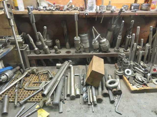 All items in pictures and contents of table and racks, except grinder - MISCELLANEOUS