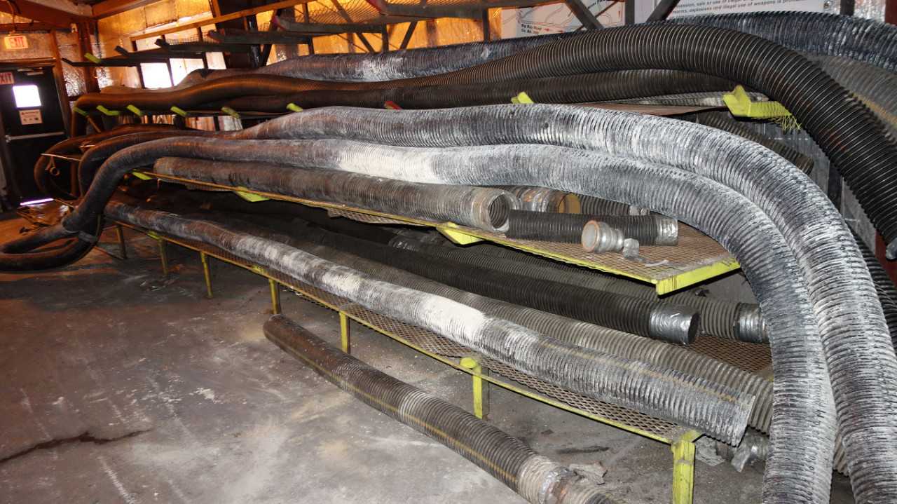 LOT OF ASSORTED HOSE ON CANTILEVER RACKNG AND BINS - ELECTRIC POWER TOOLS