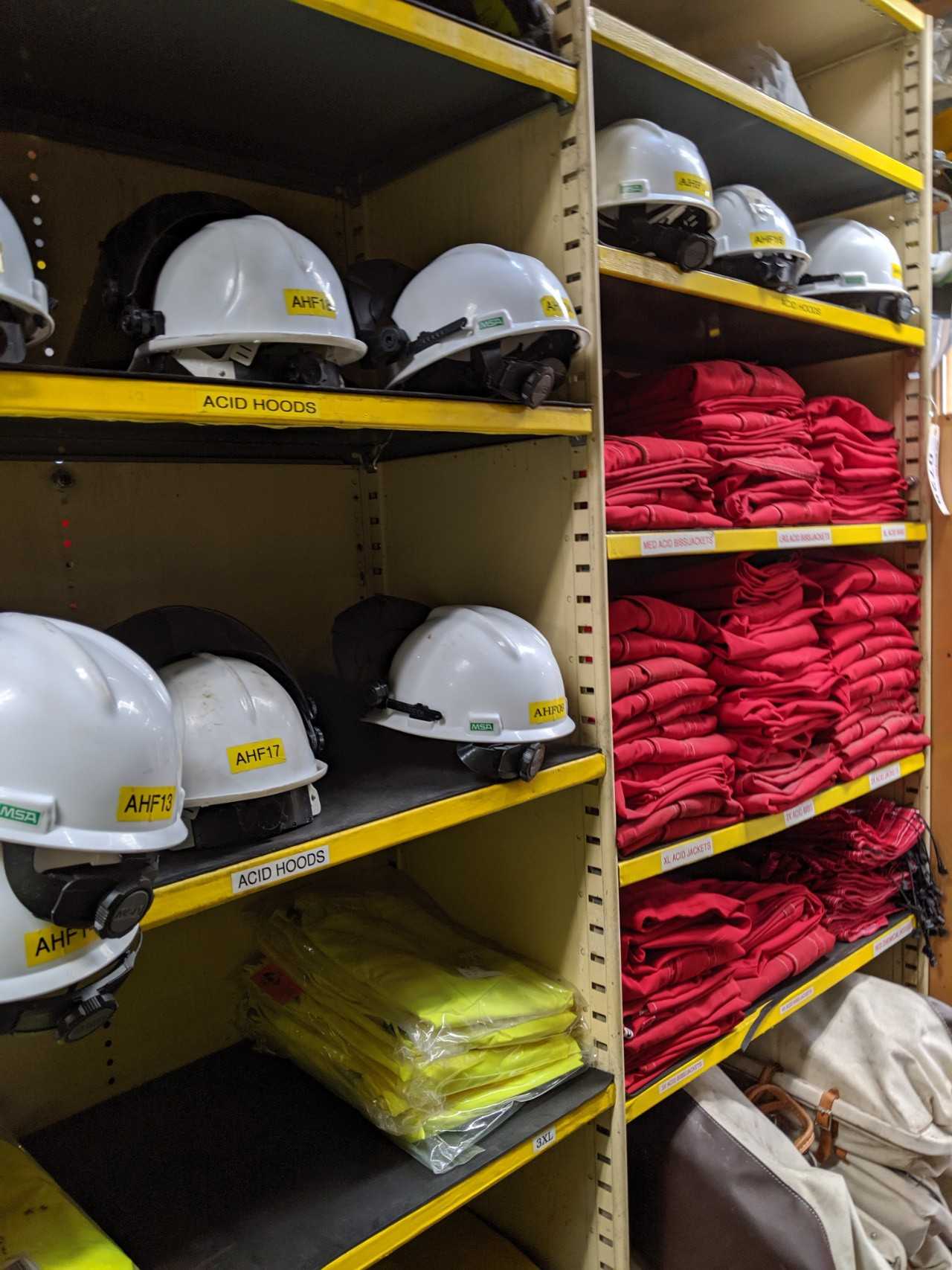 Contents of 5x sections shelving - rain jackets, hard hats, face shields, water coolers, acid bibs - SAFETY SWITCH