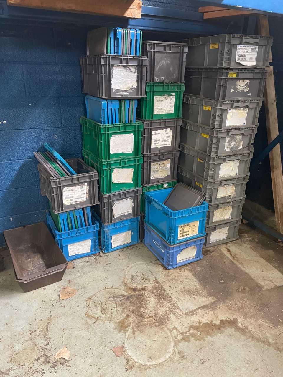 23 Plastic Totes with lids under shelves - MATERIAL HANDLING