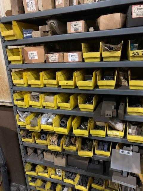 Rack with contents including screws, springs, and pins - INDUSTRIAL PARTS