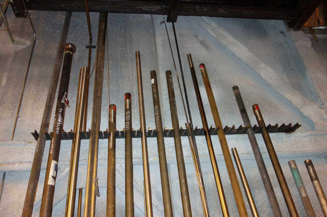 WALL OF ASSORTED BOILER TUBES, PIPES - INDUSTRIAL PARTS