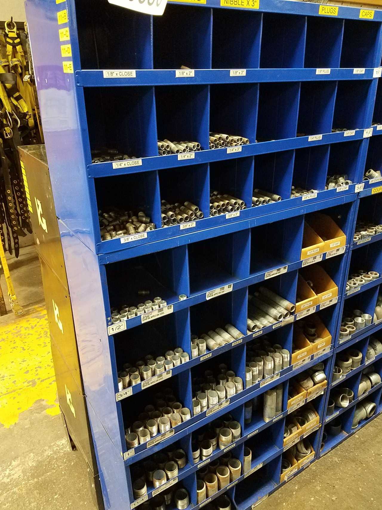 Lot of pigeon hole shelving with pipe couples, fittings, and nipples - PROCESS EQUIPMENT