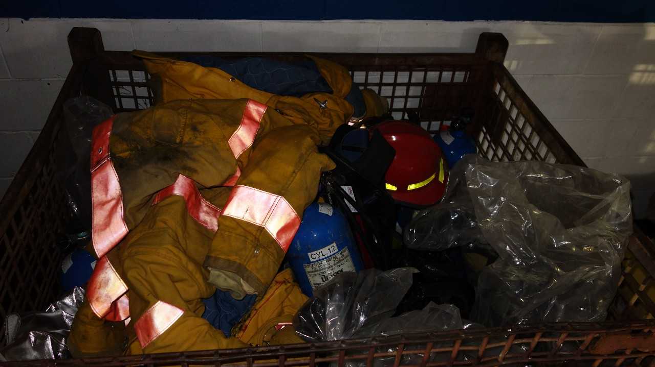 LOT OF ASSORTED FIRE PROTECTION EQUIPMENT, HARD HATS, JACKETS, EXTINGUISHERS - SAFETY EQUIPMENT
