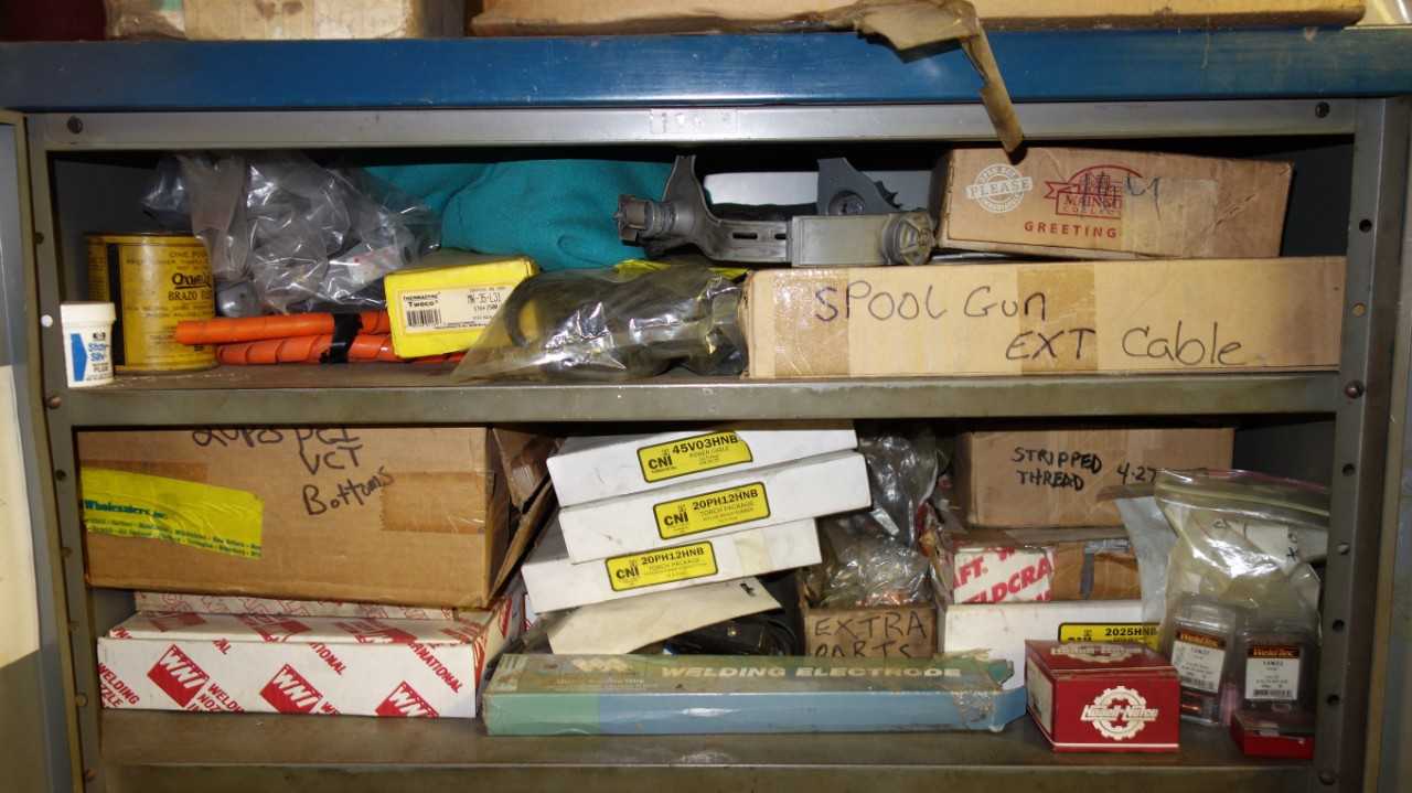 CABINET WITH CONTENTS, ASSORTED WELDING SUPPLIES, WELDING WIRE, GUN ATTACHMENTS, TORCHES, HOSES, CABLES, SAFETY HELMETS COVERALLS,  ELECTRODES, REGULATORS, CNI, UNION CARBIDE, LTECH, TWECO - WELDING EQUIPMENT