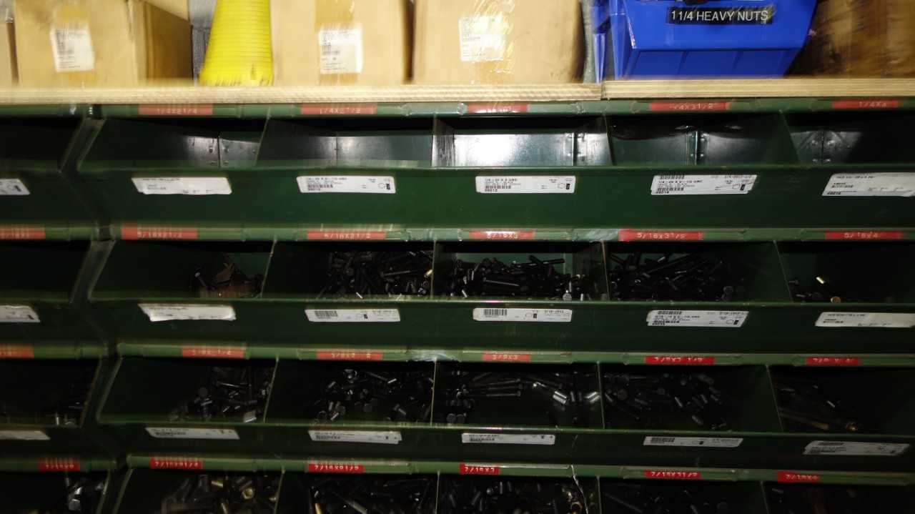 SHELVES OF ASSORTED THREADED SCREWS AND NUTS - INDUSTRIAL PARTS