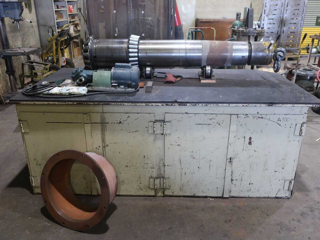Steel work table 4'x8' with contents (hydraulic pump and large shaft not included) - MATERIAL HANDLING
