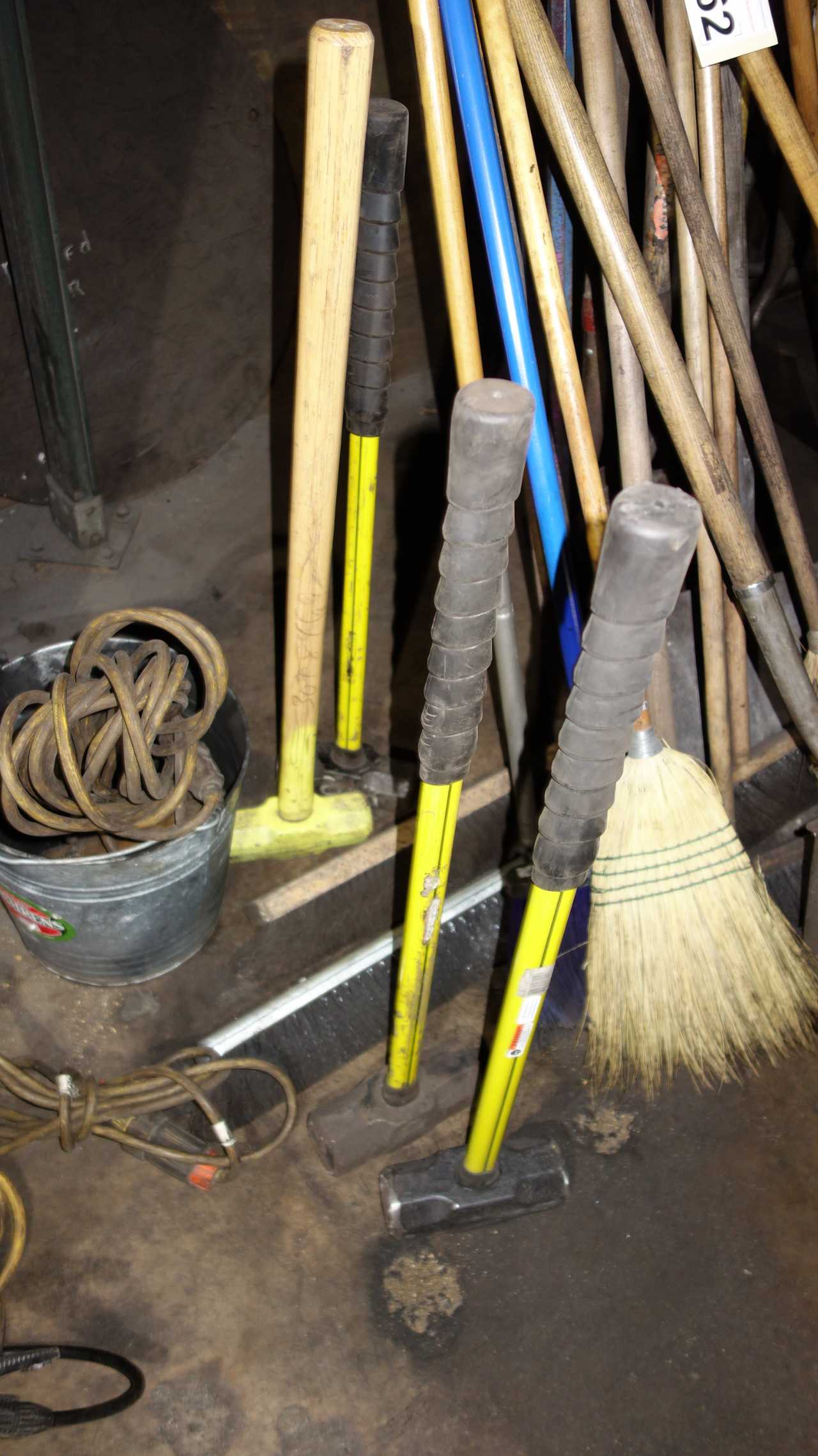 LOT OF ASSORTED BROOMS, SLEDGE HAMMERS, SHOVELS - HAND TOOLS