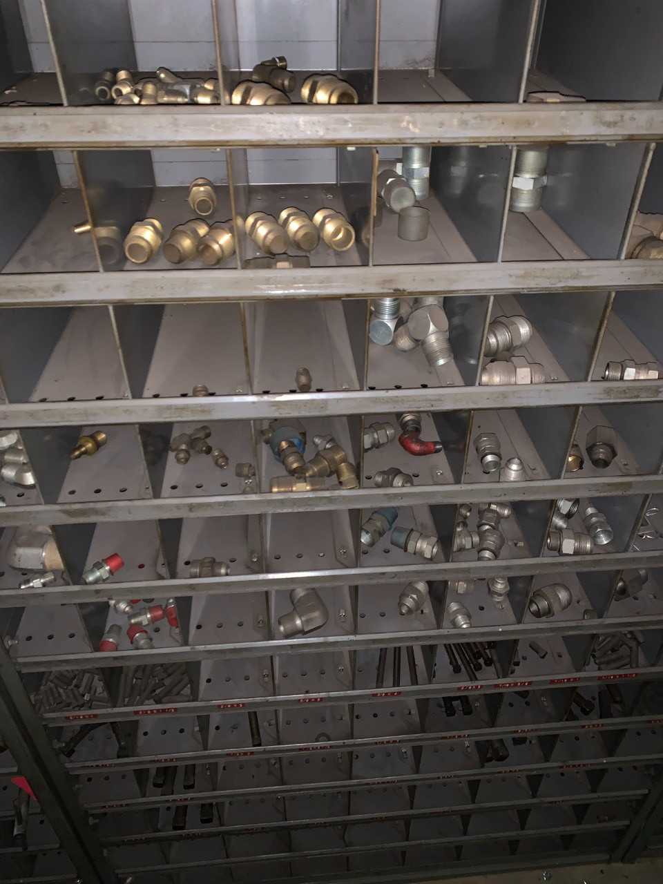 Large wall unit filled with fittings - INDUSTRIAL PARTS