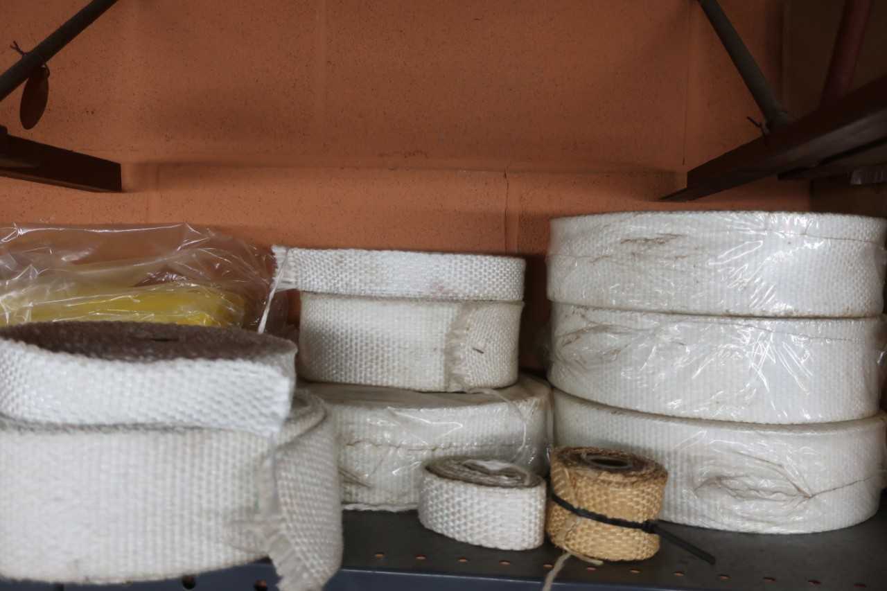CONTENTS OF SHELF, ASSORTED CONSUMABLE SAFETY SUPPLIES, CAUTION TAPE, ASBESTOS TAPE, DUCT TAPE, SCOTCH TAPE, LUBRICANT - SAFETY EQUIPMENT